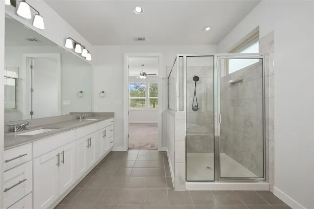 a spacious bathroom with a granite countertop sink mirror and a toilet