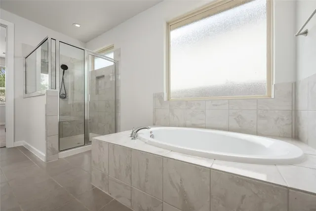 a spacious bathroom with a shower sink and mirror