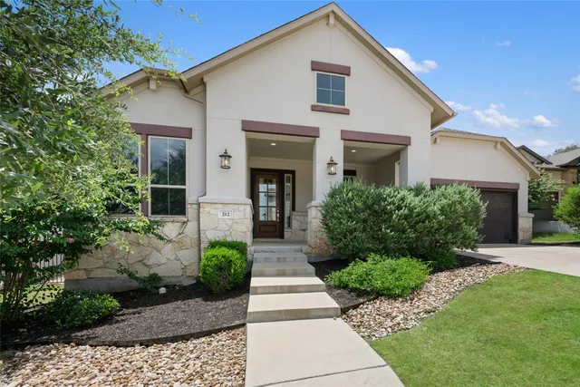 a front view of a house with garden