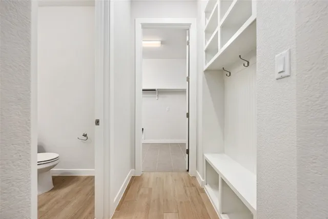 a view of empty room with wooden floor