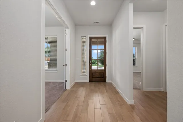a view of hallway with wooden floor