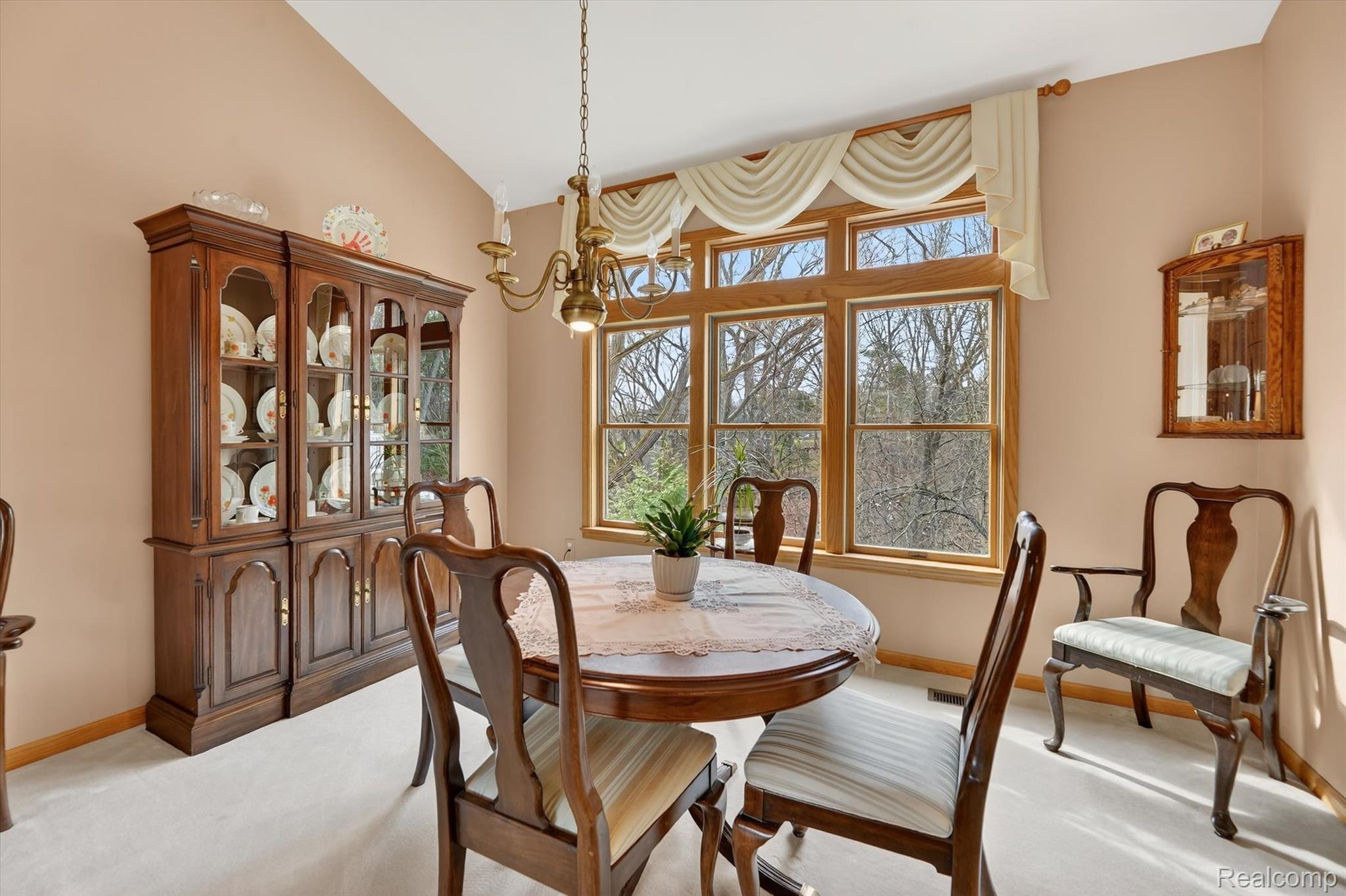 7798 Lee Road Brighton, MI 48116 - Photo 8 of 49 Dining space featuring lofted ceiling, light colored carpet, and suspended lighting