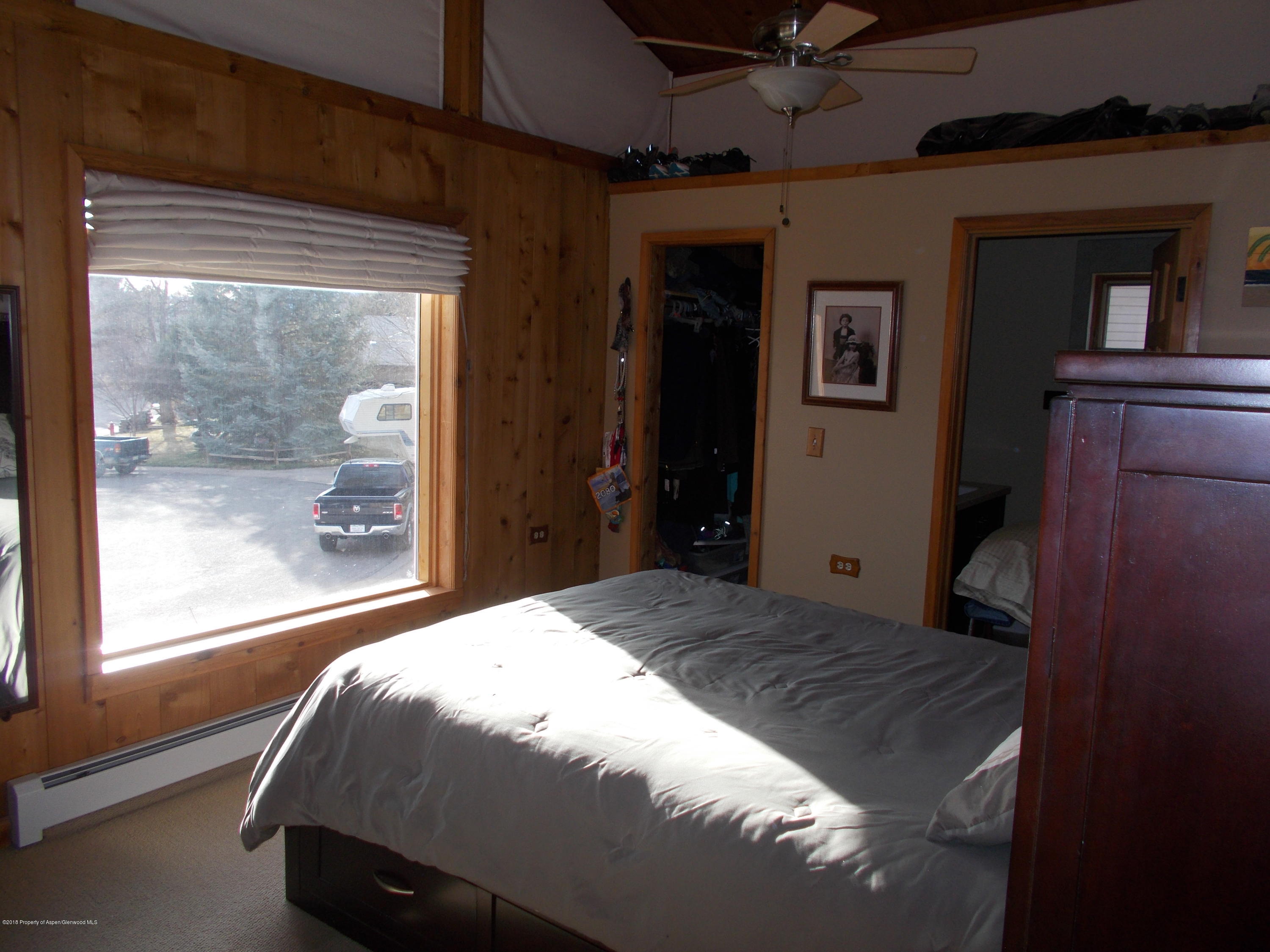 712 Buckeye Court Rifle, CO 81650 - Photo 14 of 22 a bedroom with a bed and large window