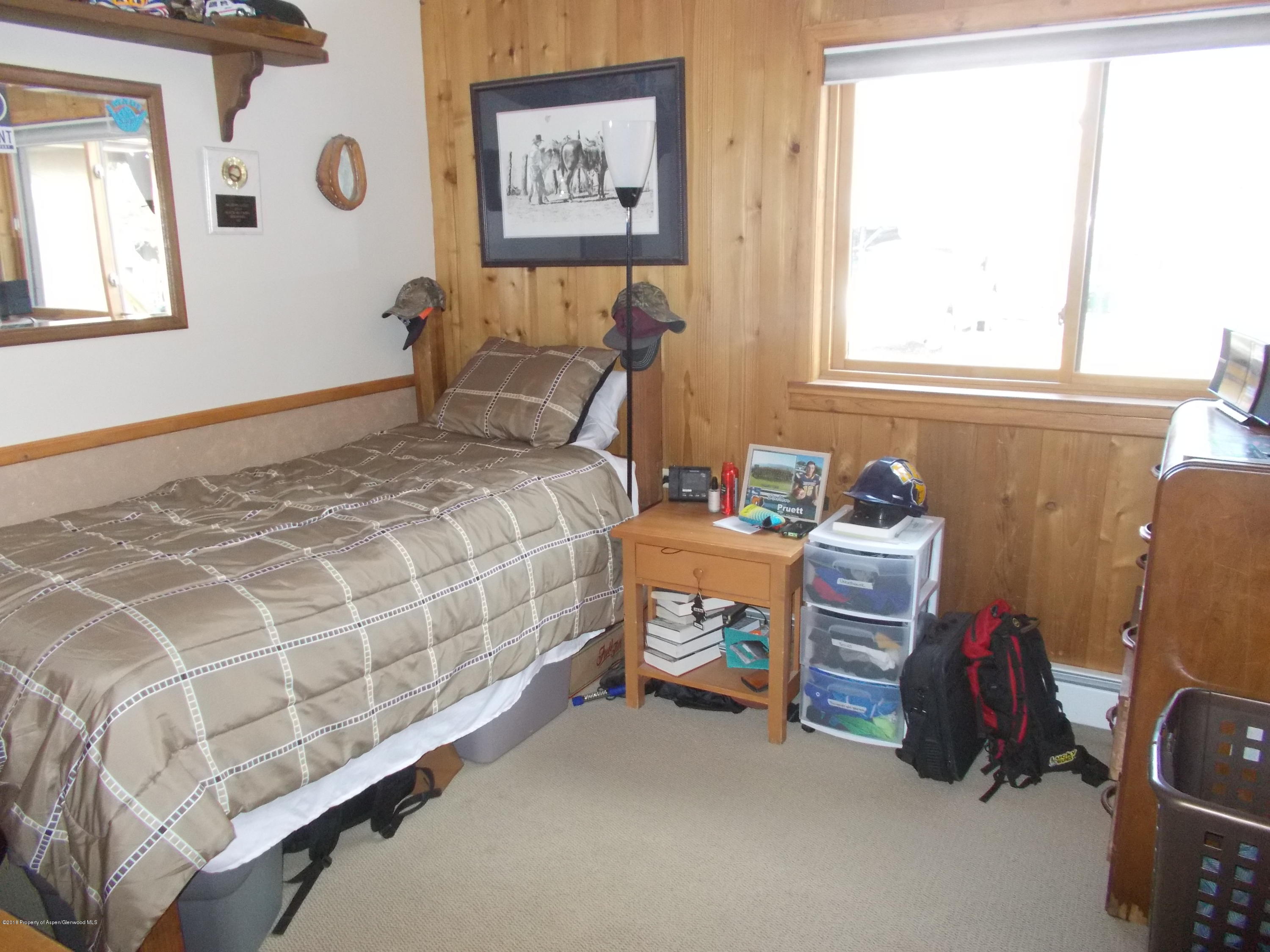 712 Buckeye Court Rifle, CO 81650 - Photo 15 of 22 a bedroom with a bed and a window