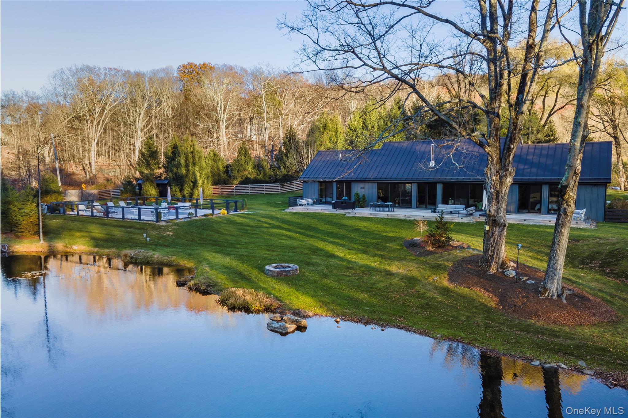 Backyard with pond, pool and beautiful outdoor spaces.