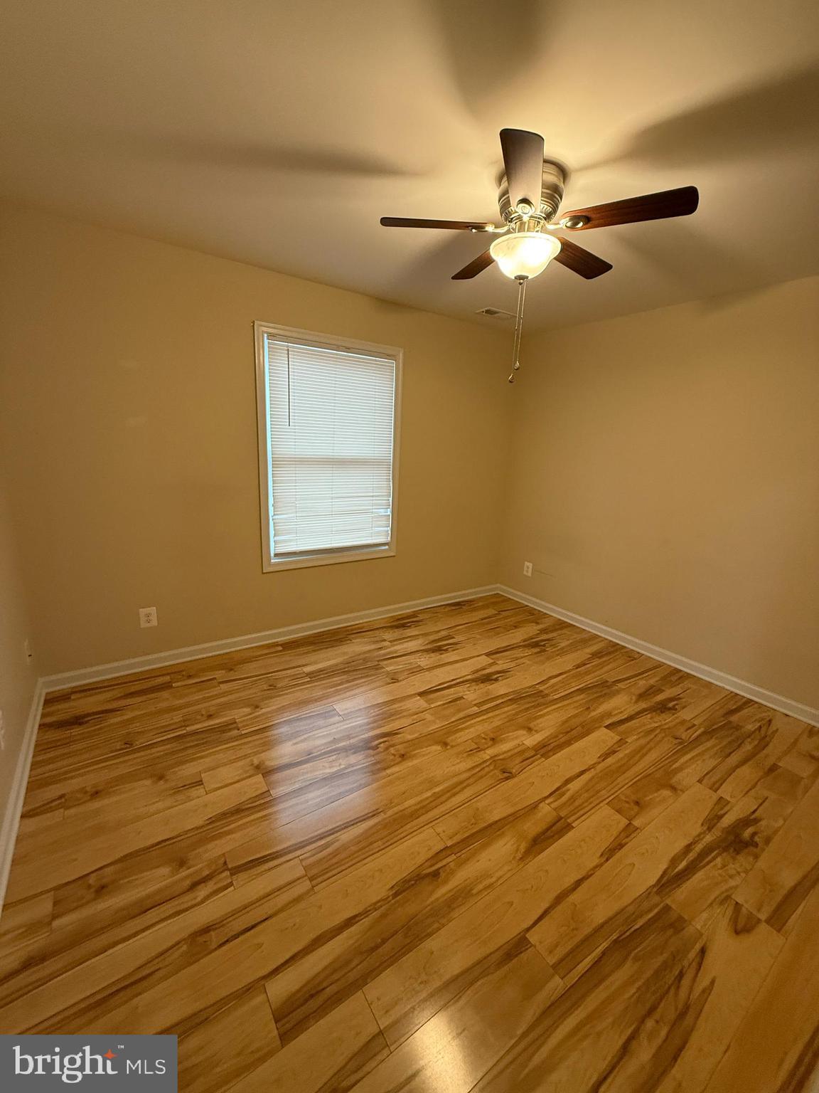 3385 Howellsville Road Front Royal, VA 22630 - Photo 13 of 19 a view of an empty room with wooden floor and a fan