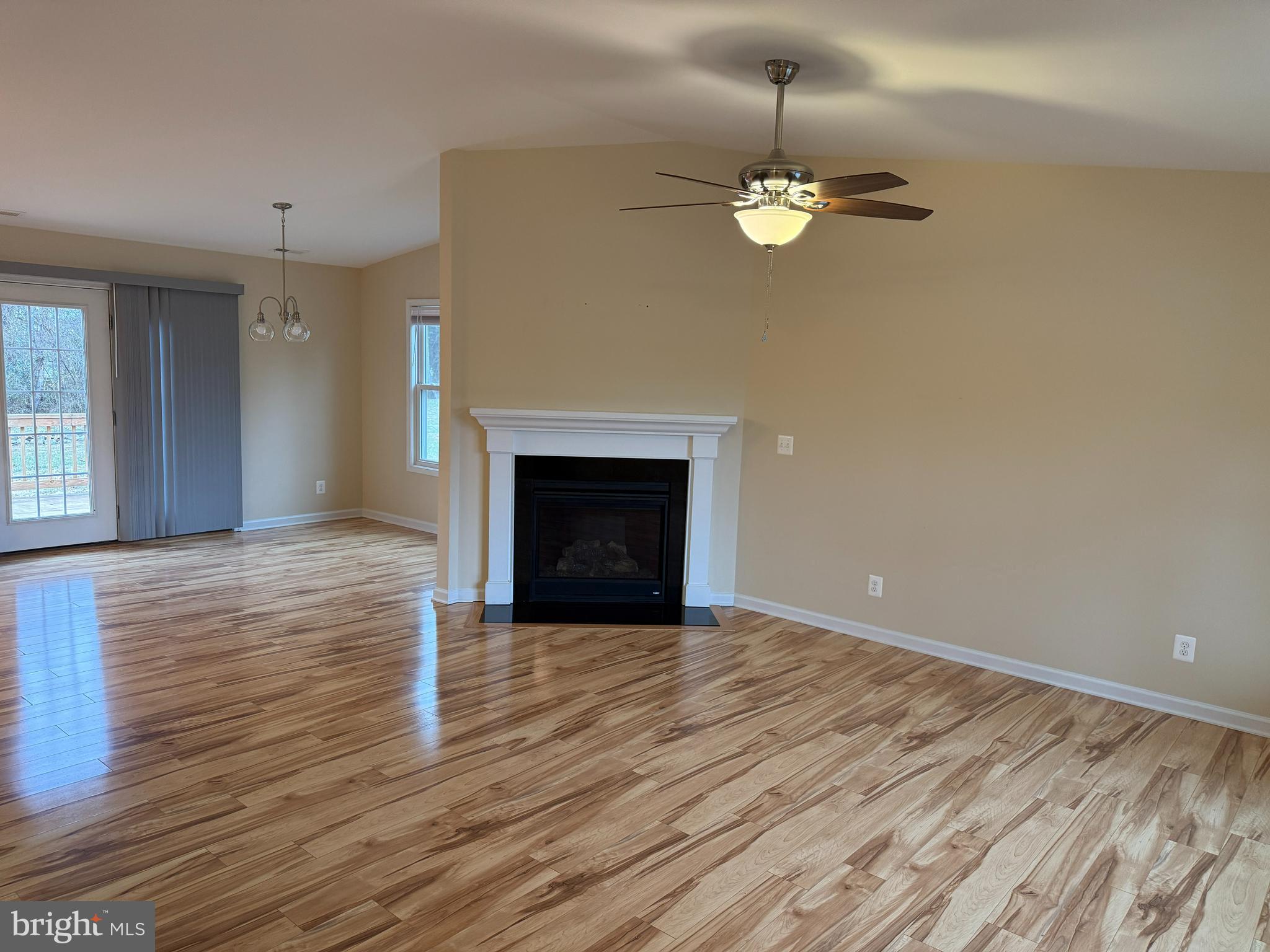 3385 Howellsville Road Front Royal, VA 22630 - Photo 3 of 19 a view of an empty room with wooden floor fireplace and a window