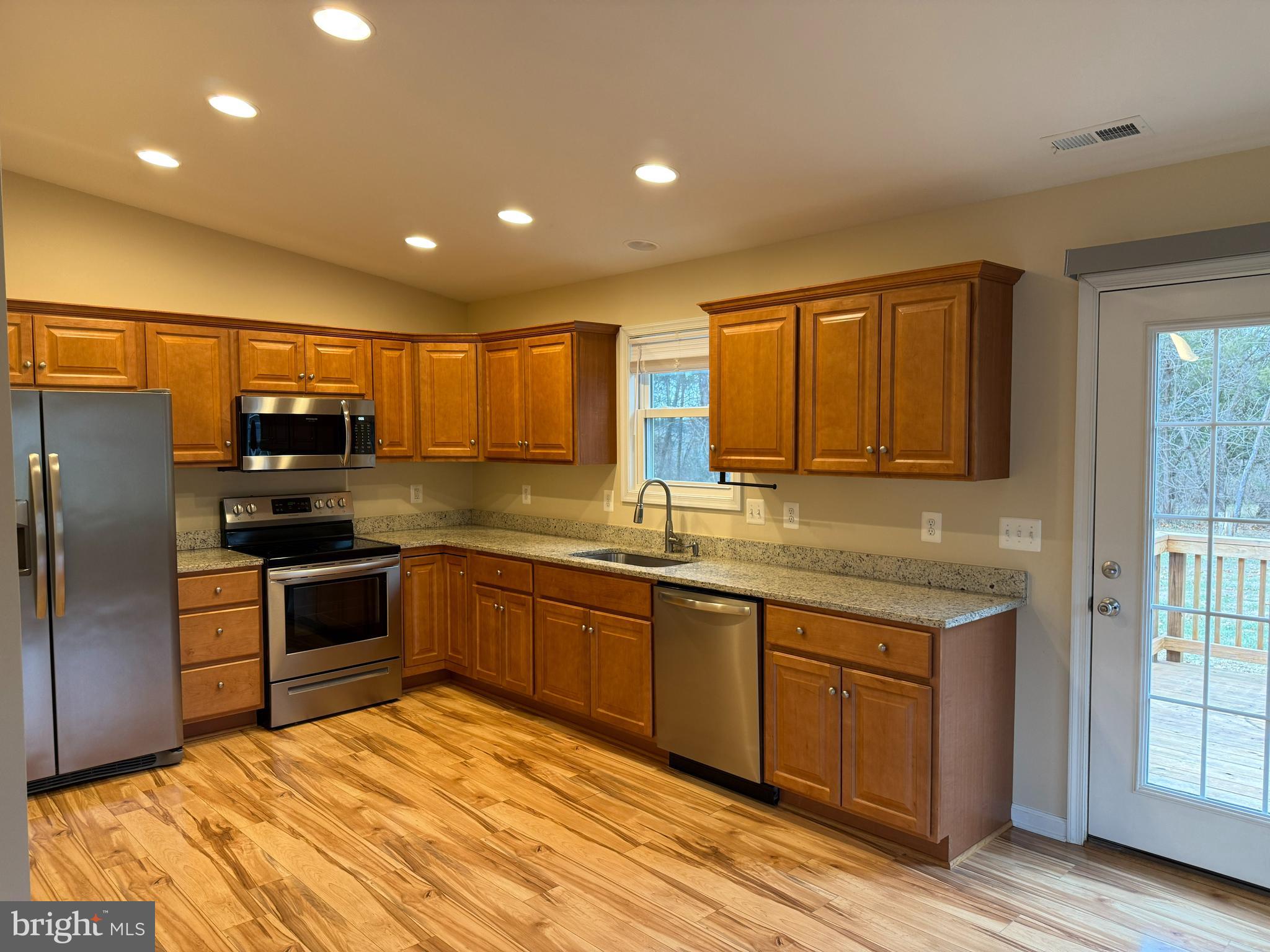 3385 Howellsville Road Front Royal, VA 22630 - Photo 5 of 19 a kitchen with stainless steel appliances granite countertop a refrigerator and wooden cabinets