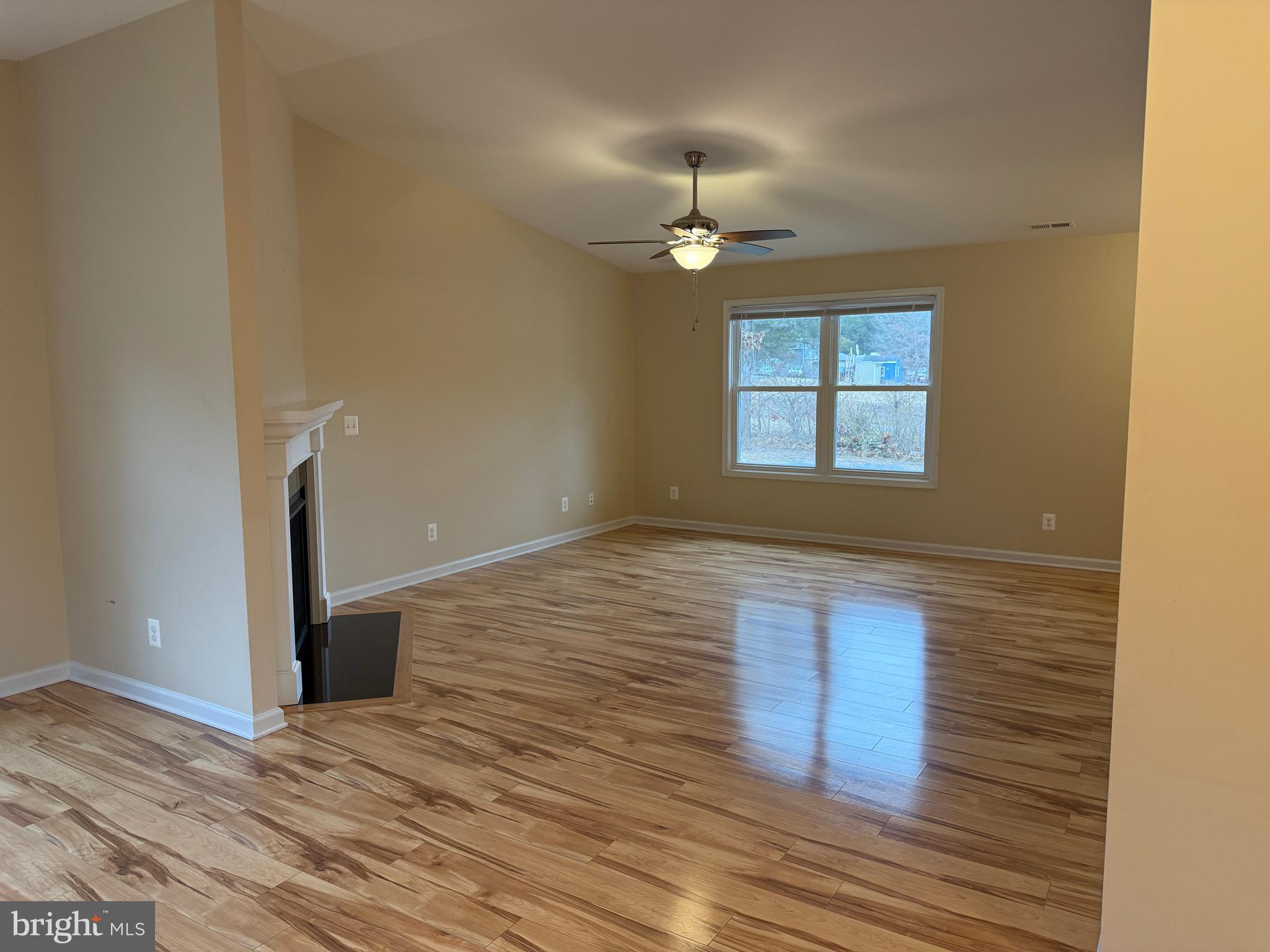 3385 Howellsville Road Front Royal, VA 22630 - Photo 10 of 19 an empty room with wooden floor chandelier and windows