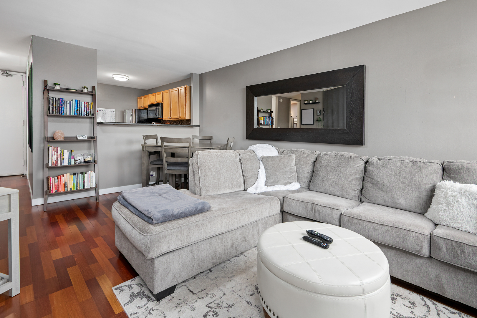 655 West Irving Park Road, Unit 705 Chicago, IL 60613 - Photo 2 of 9 a living room with furniture and a flat screen tv