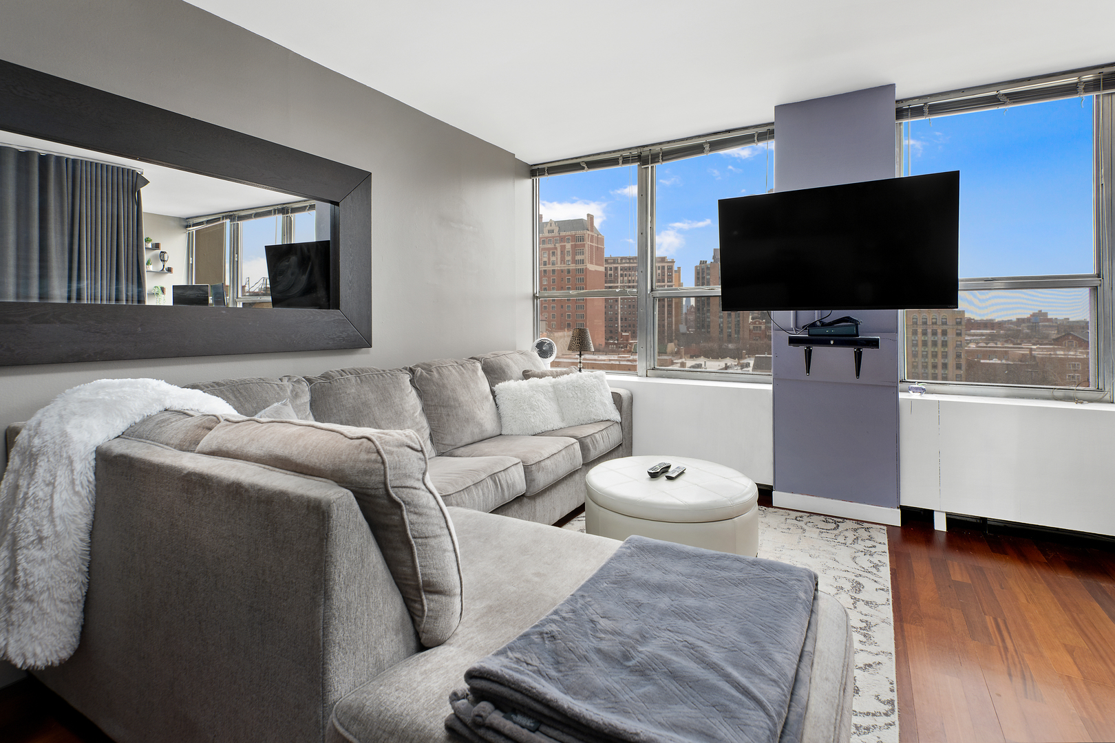 655 West Irving Park Road, Unit 705 Chicago, IL 60613 - Photo 3 of 9 a living room with furniture and a flat screen tv