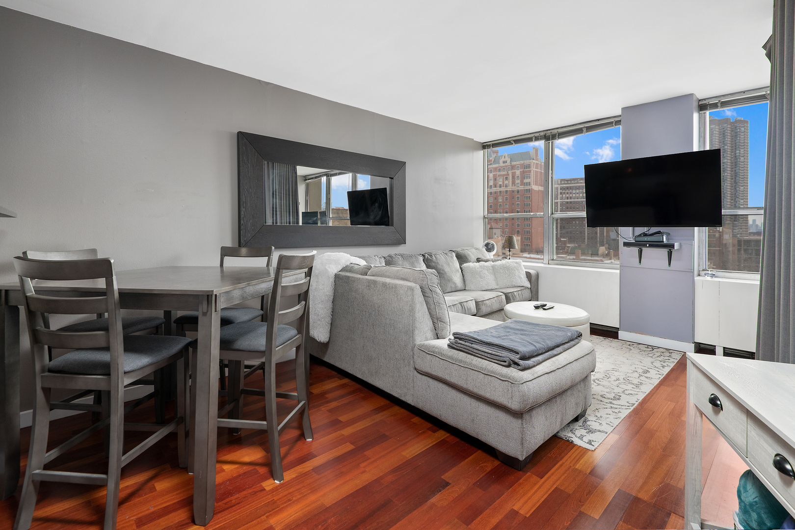 655 West Irving Park Road, Unit 705 Chicago, IL 60613 - Photo 6 of 9 a living room with furniture and a flat screen tv