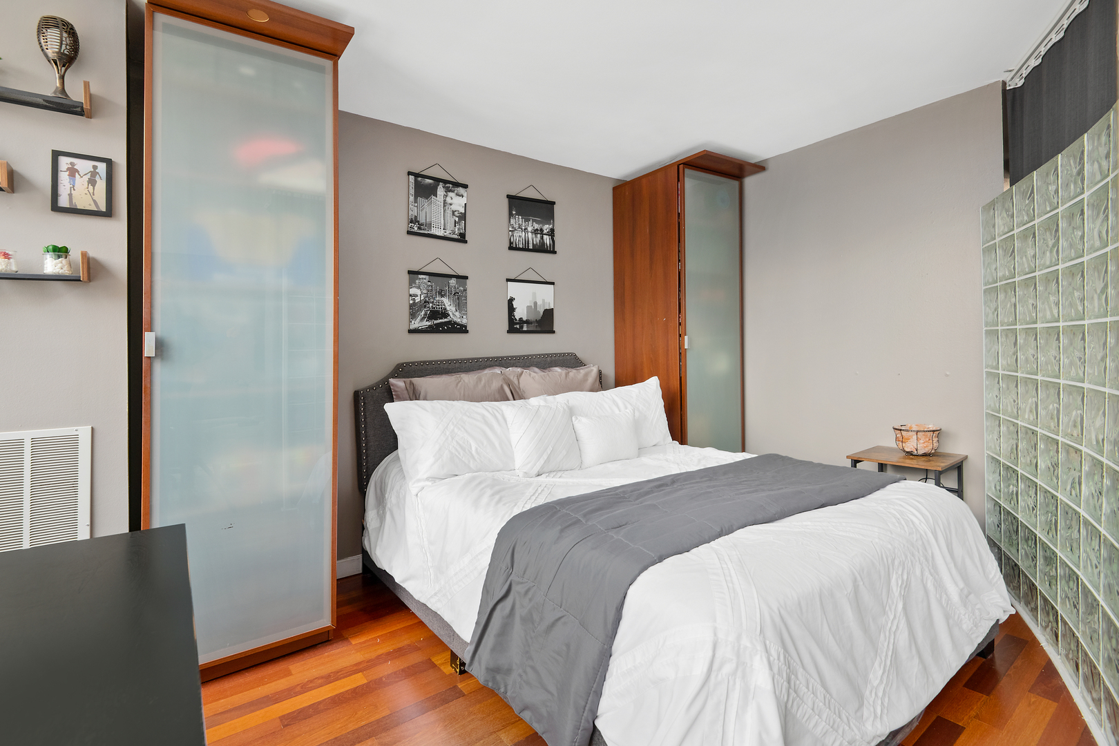 655 West Irving Park Road, Unit 705 Chicago, IL 60613 - Photo 7 of 9 a bed sitting in a bedroom next to a cabinet