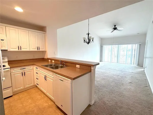 a kitchen with a stove and white cabinets