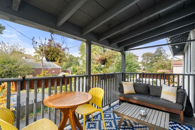 a view of a chair and tables in the balcony