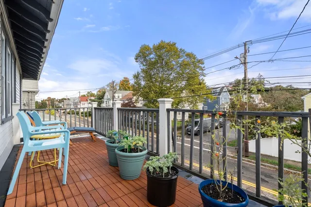 a balcony with filled with furniture and potted plants