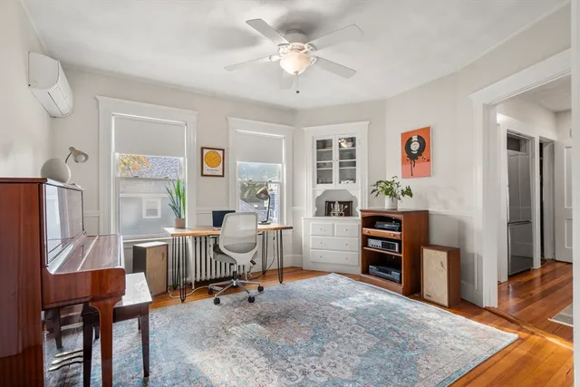 a view of a workspace with furniture and a window