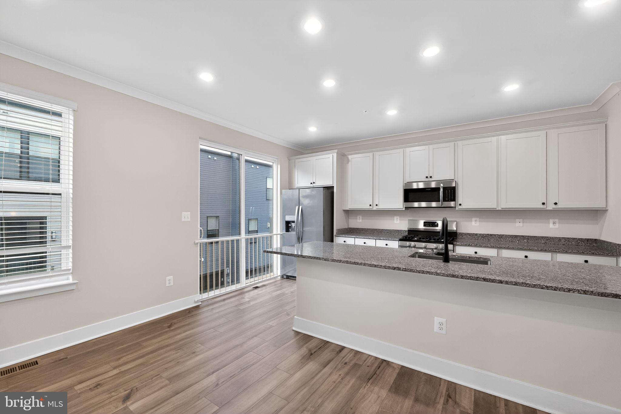 1505 Roland Heights Avenue Baltimore, MD 21211 - Photo 12 of 36 a kitchen with stainless steel appliances a refrigerator sink and microwave