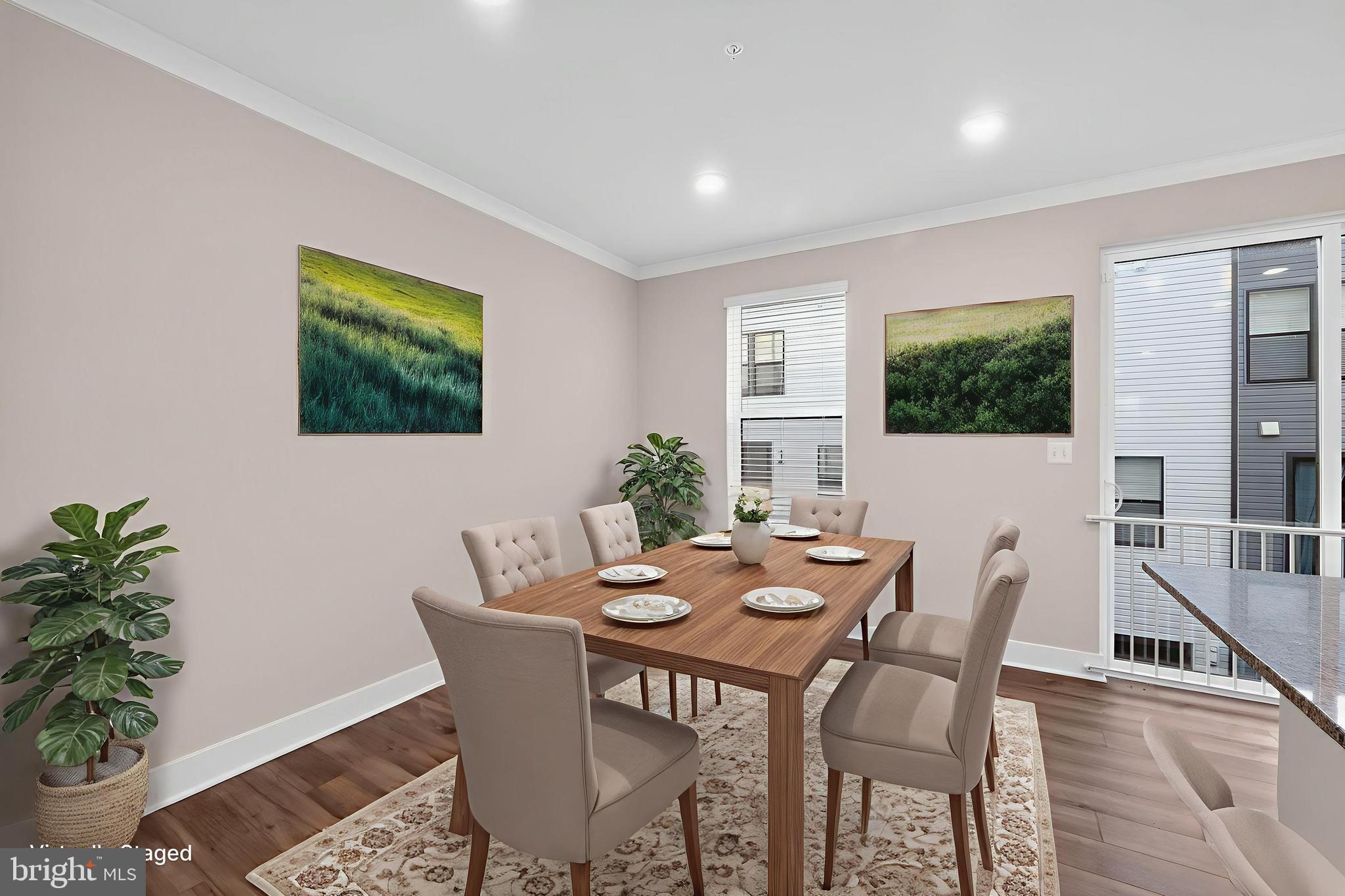 1505 Roland Heights Avenue Baltimore, MD 21211 - Photo 22 of 36 a view of a dining room with furniture and potted plants