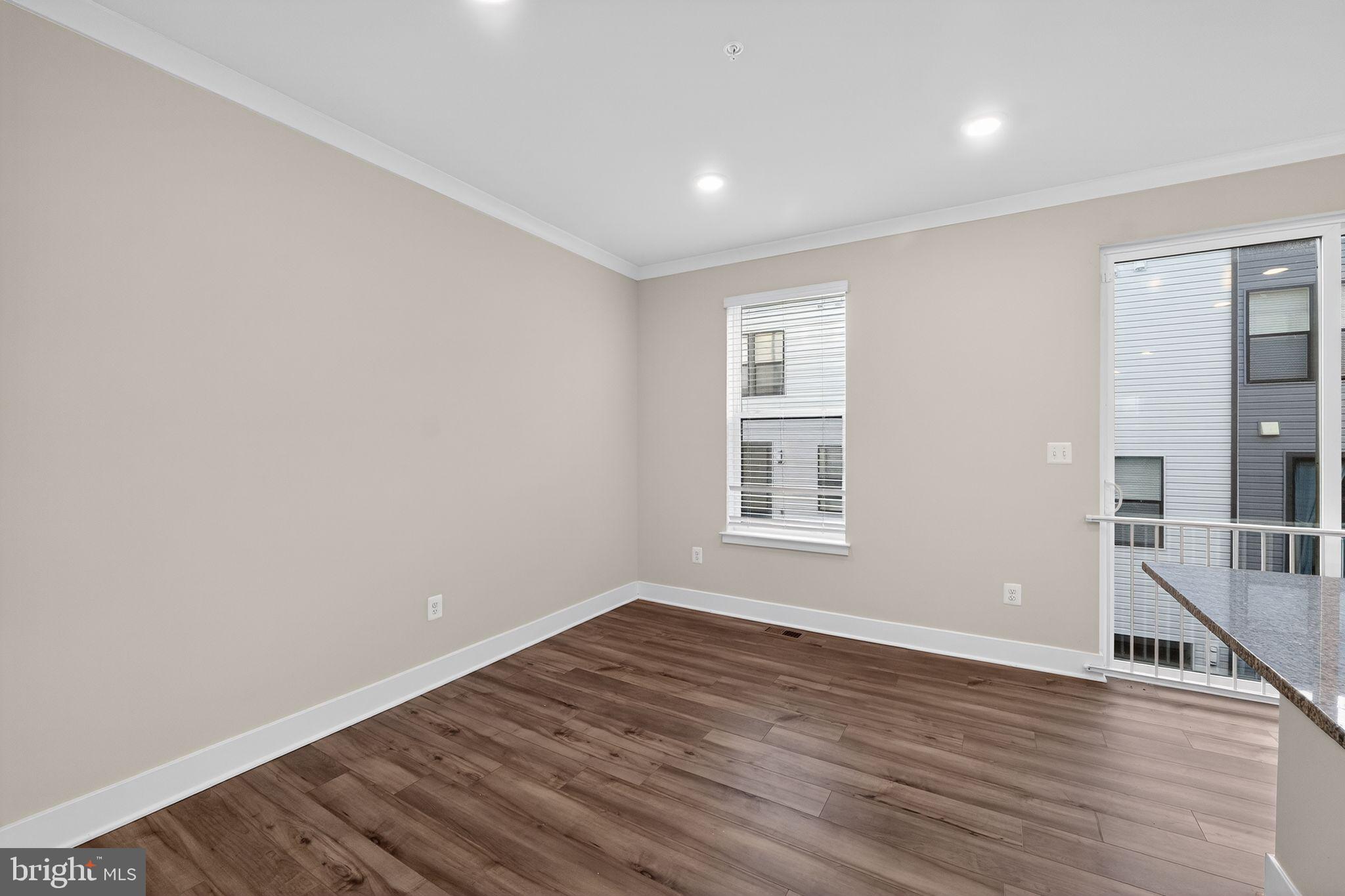 1505 Roland Heights Avenue Baltimore, MD 21211 - Photo 23 of 36 a view of empty room with wooden floor and fan