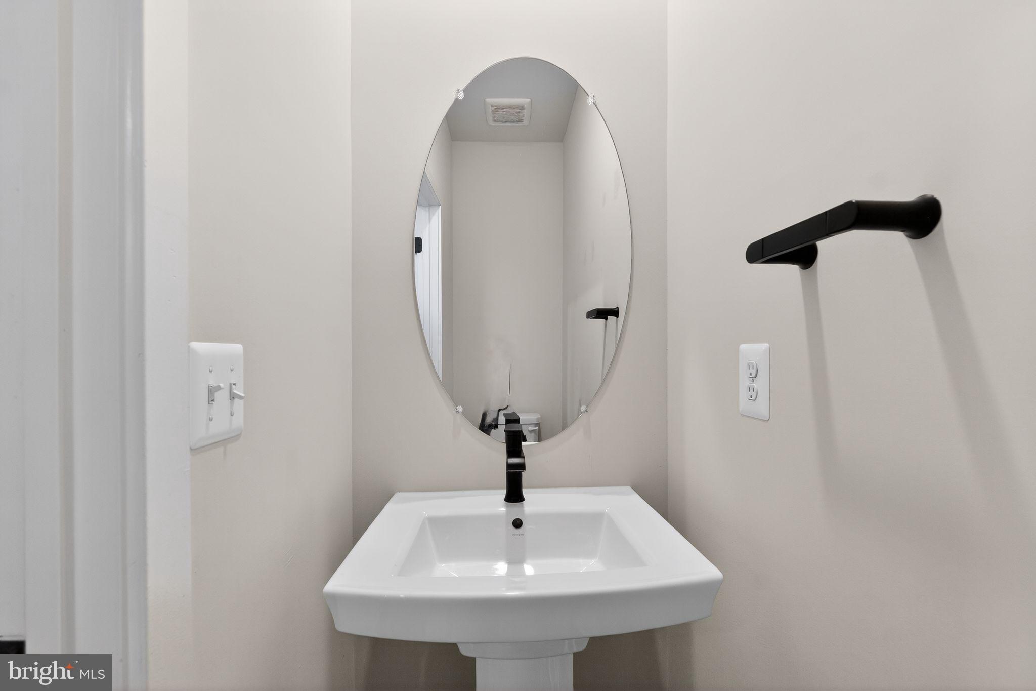 1505 Roland Heights Avenue Baltimore, MD 21211 - Photo 24 of 36 a bathroom with a sink and a mirror