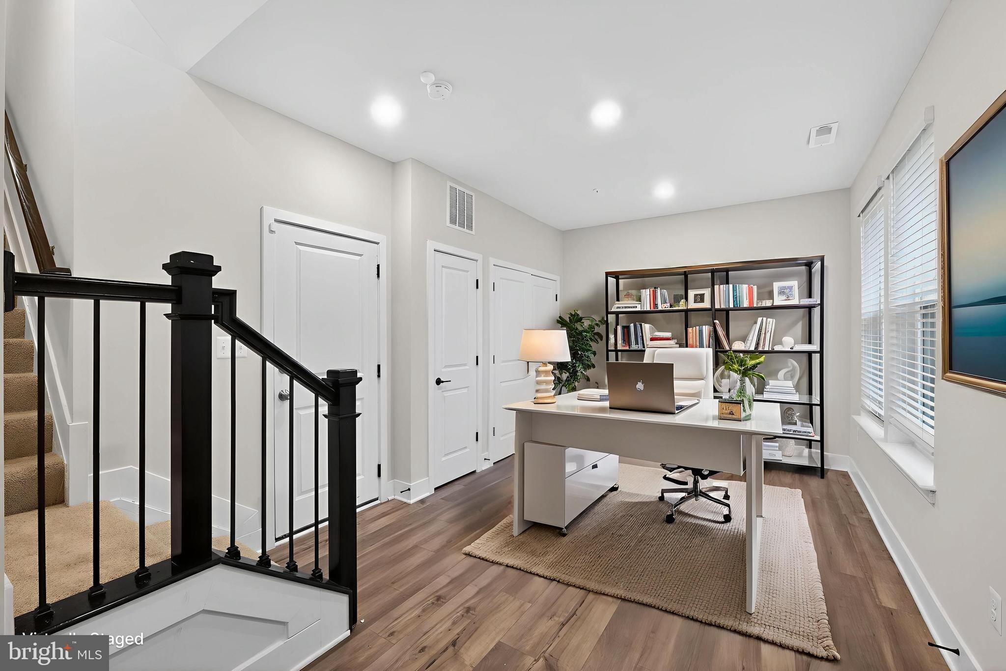 1505 Roland Heights Avenue Baltimore, MD 21211 - Photo 3 of 36 a room with furniture a rug and a book shelf