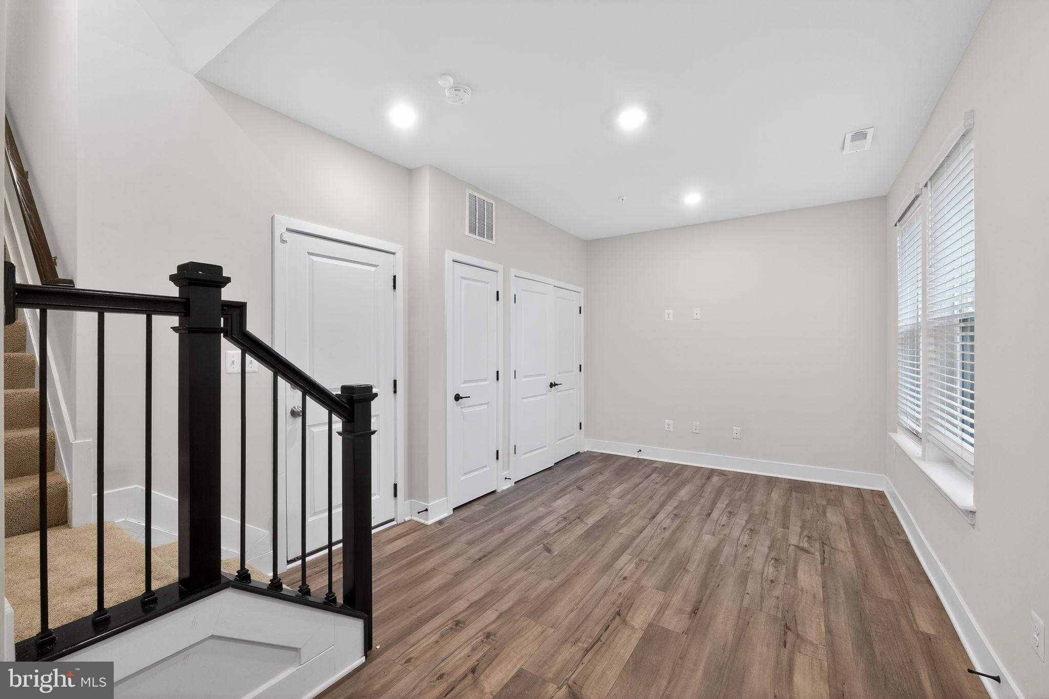 1505 Roland Heights Avenue Baltimore, MD 21211 - Photo 4 of 36 a view of a hallway with wooden floor and staircase