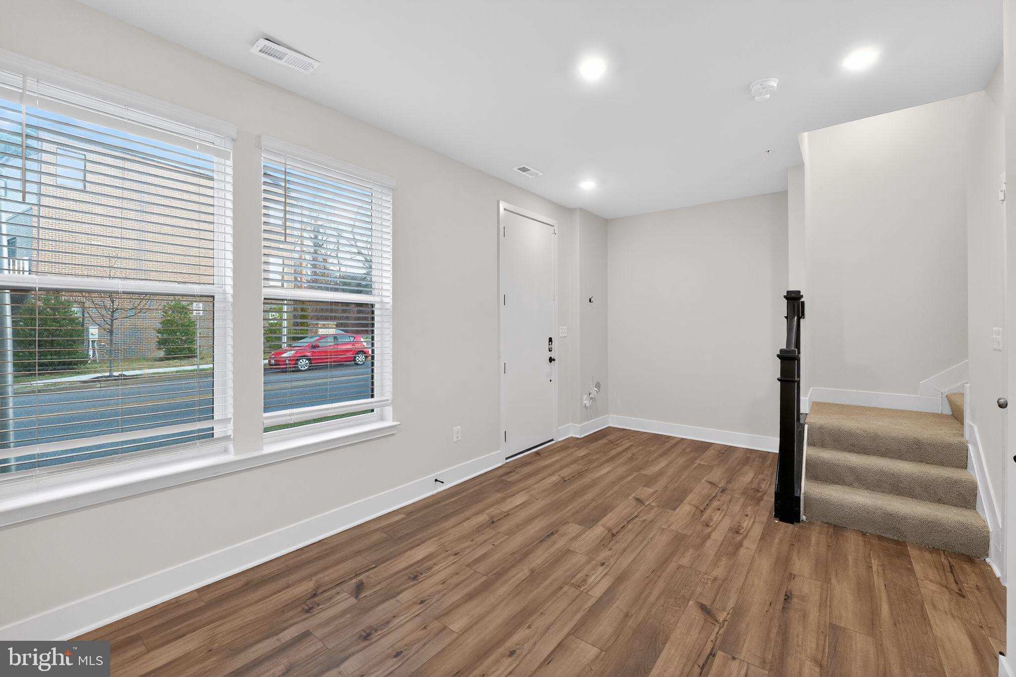 1505 Roland Heights Avenue Baltimore, MD 21211 - Photo 5 of 36 a view of empty room with wooden floor and fan