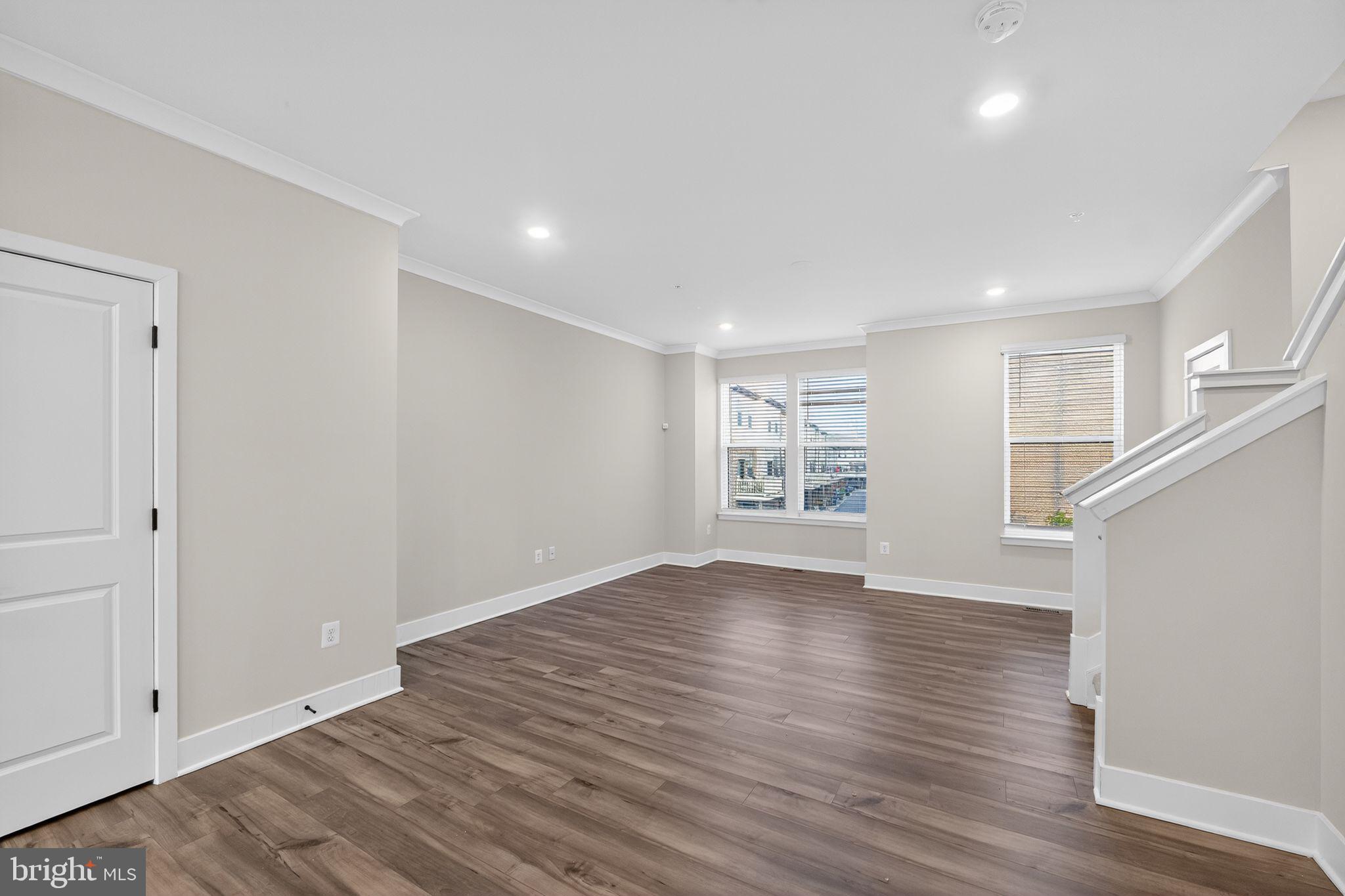1505 Roland Heights Avenue Baltimore, MD 21211 - Photo 7 of 36 a view of empty room with wooden floor and fan