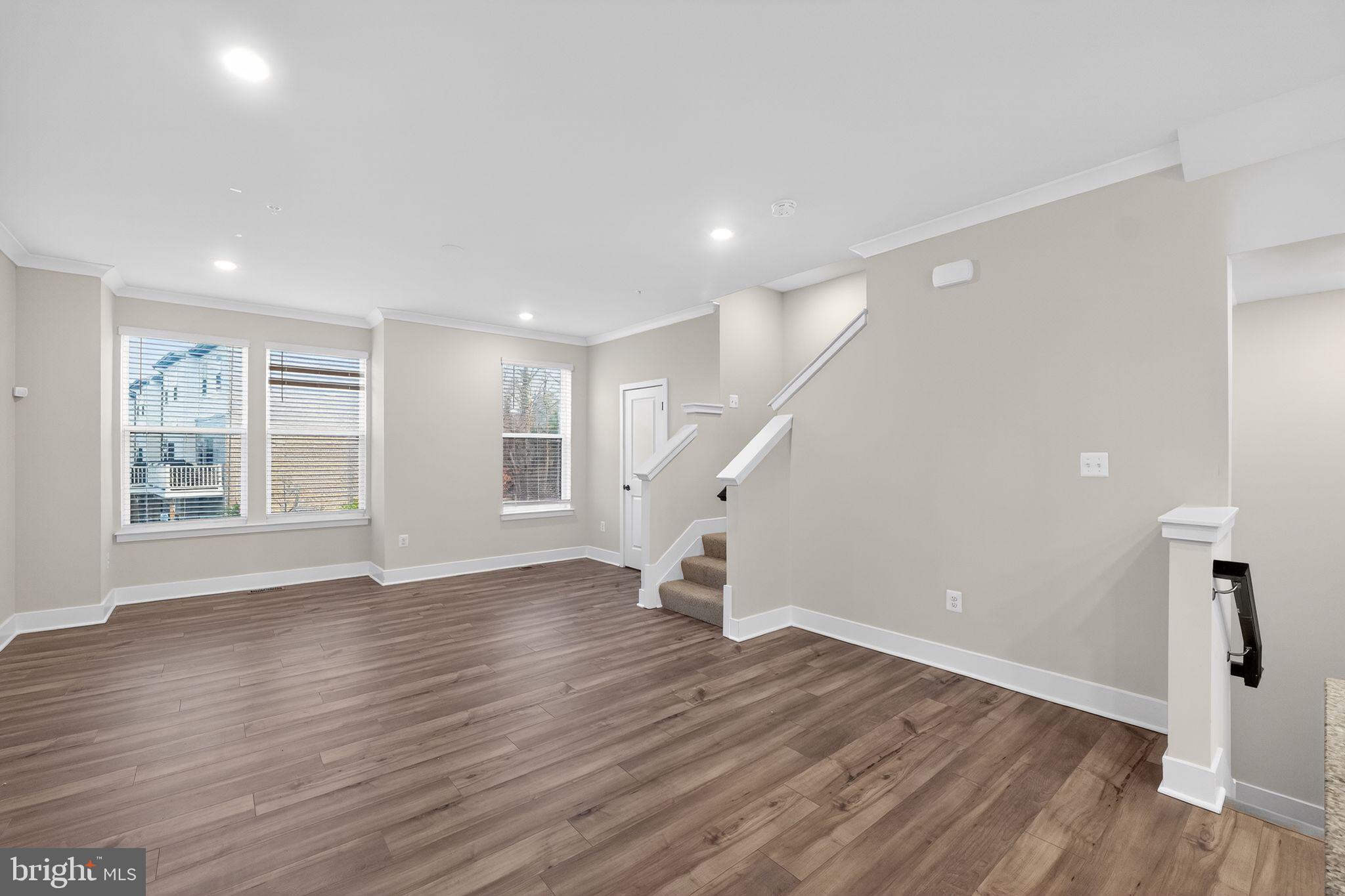 1505 Roland Heights Avenue Baltimore, MD 21211 - Photo 8 of 36 a view of empty room with wooden floor and fan