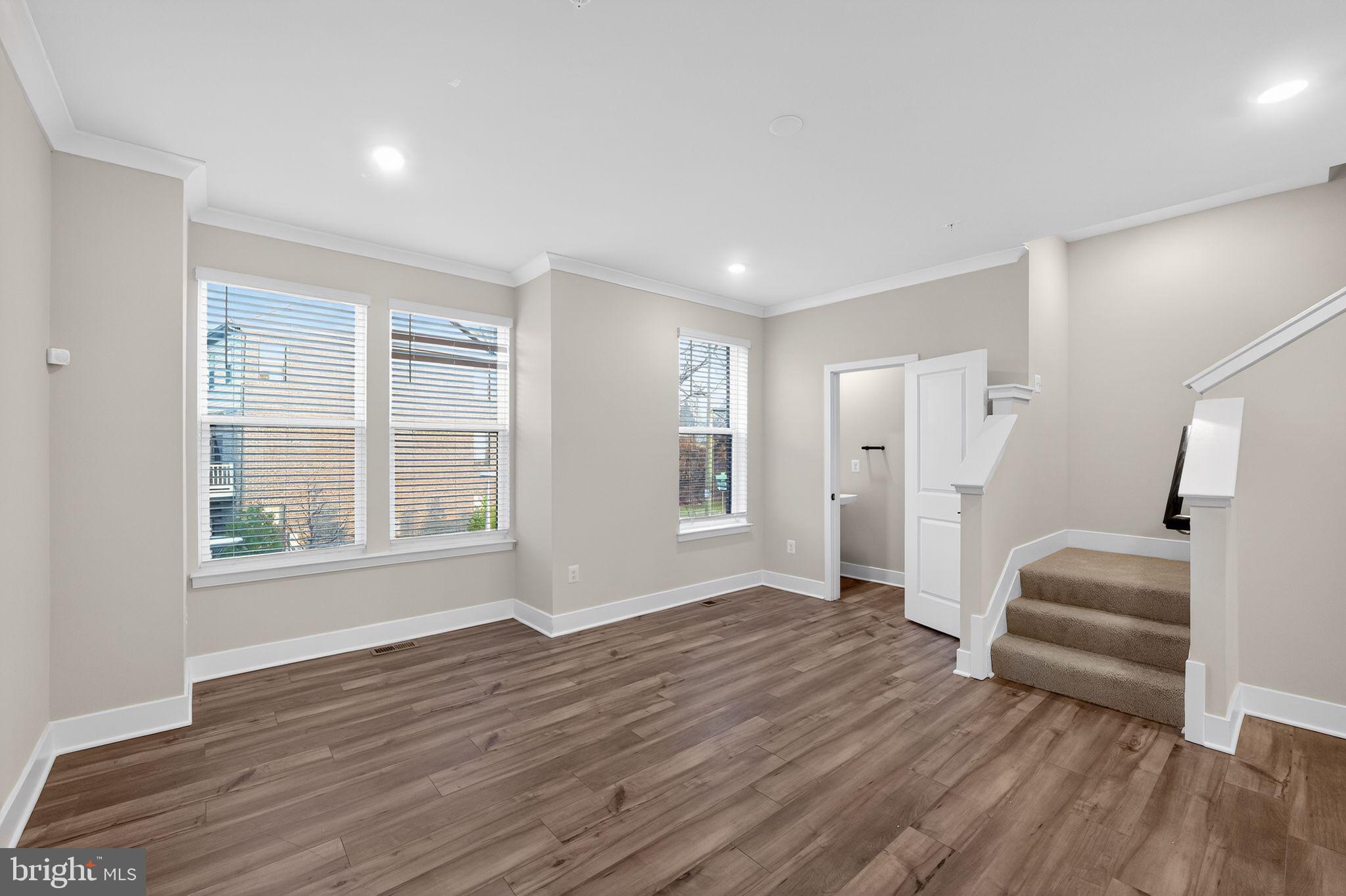 1505 Roland Heights Avenue Baltimore, MD 21211 - Photo 9 of 36 a view of empty room with wooden floor and fan