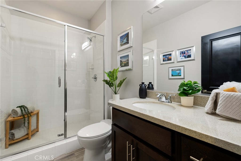 25313 High Noon Court Menifee, CA 92584 - Photo 11 of 73 a bathroom with a granite countertop sink toilet and shower