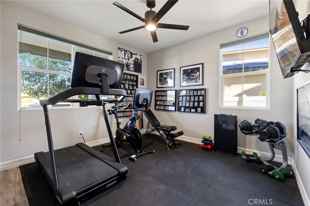 25313 High Noon Court Menifee, CA 92584 - Photo 12 of 73 a room with gym equipment and windows