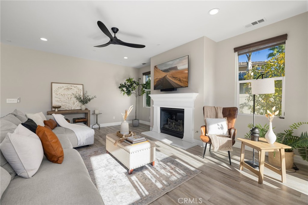 25313 High Noon Court Menifee, CA 92584 - Photo 17 of 73 a living room with furniture a flat screen tv and a fireplace