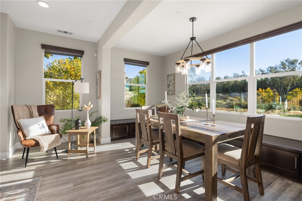 25313 High Noon Court Menifee, CA 92584 - Photo 18 of 73 a dining room with furniture window and wooden floor