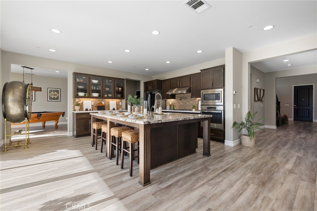 25313 High Noon Court Menifee, CA 92584 - Photo 20 of 73 a kitchen with lots of counter top space and stainless steel appliances