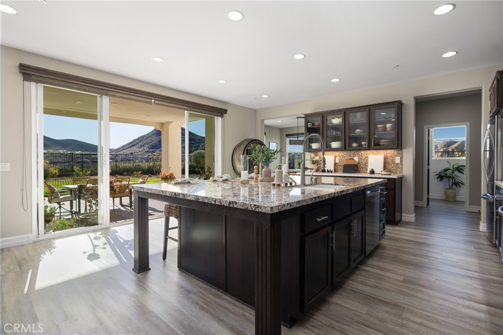 25313 High Noon Court Menifee, CA 92584 - Photo 22 of 73 a kitchen with counter top space and wooden floor