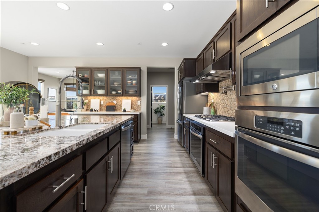 25313 High Noon Court Menifee, CA 92584 - Photo 23 of 73 a large kitchen with stainless steel appliances