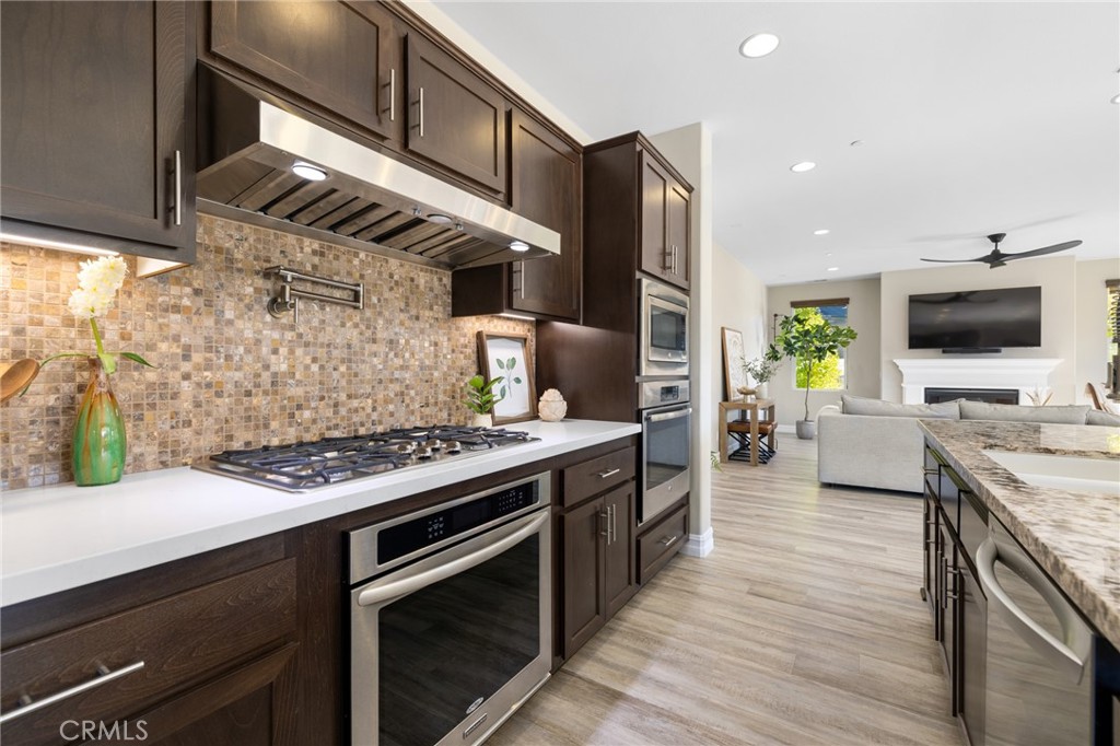 25313 High Noon Court Menifee, CA 92584 - Photo 24 of 73 a kitchen with a stove and a microwave