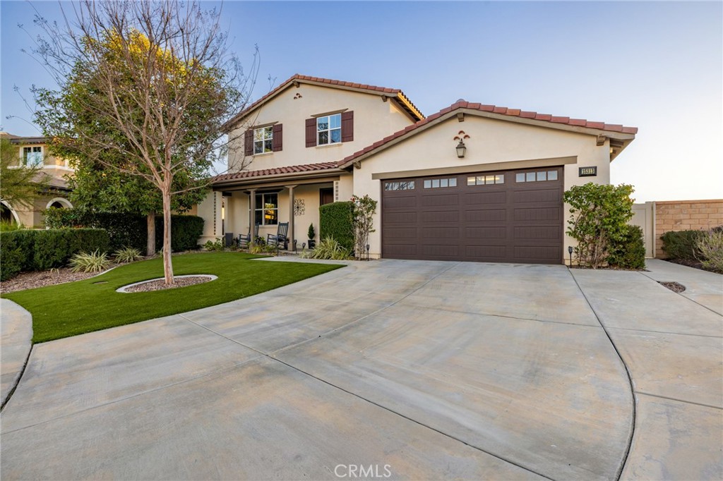 25313 High Noon Court Menifee, CA 92584 - Photo 3 of 73 a front view of a house with a yard and garage