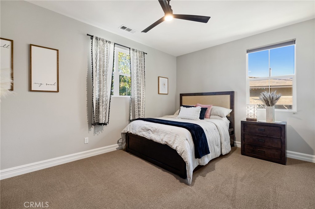 25313 High Noon Court Menifee, CA 92584 - Photo 36 of 73 a spacious bedroom with a bed and window