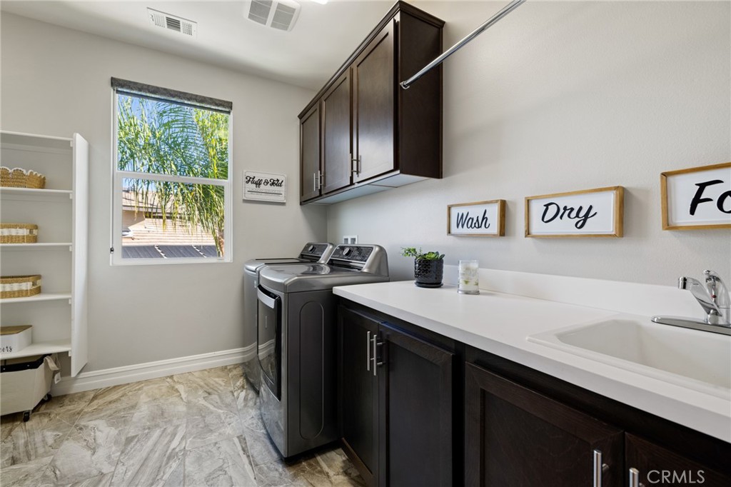 25313 High Noon Court Menifee, CA 92584 - Photo 37 of 73 a kitchen with stainless steel appliances granite countertop a sink stove and refrigerator