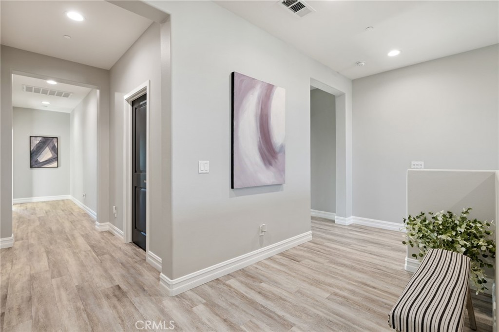 25313 High Noon Court Menifee, CA 92584 - Photo 39 of 73 a view of a room with wooden floor and entryway