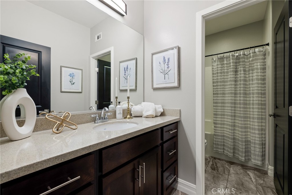 25313 High Noon Court Menifee, CA 92584 - Photo 40 of 73 a bathroom with a sink and a mirror