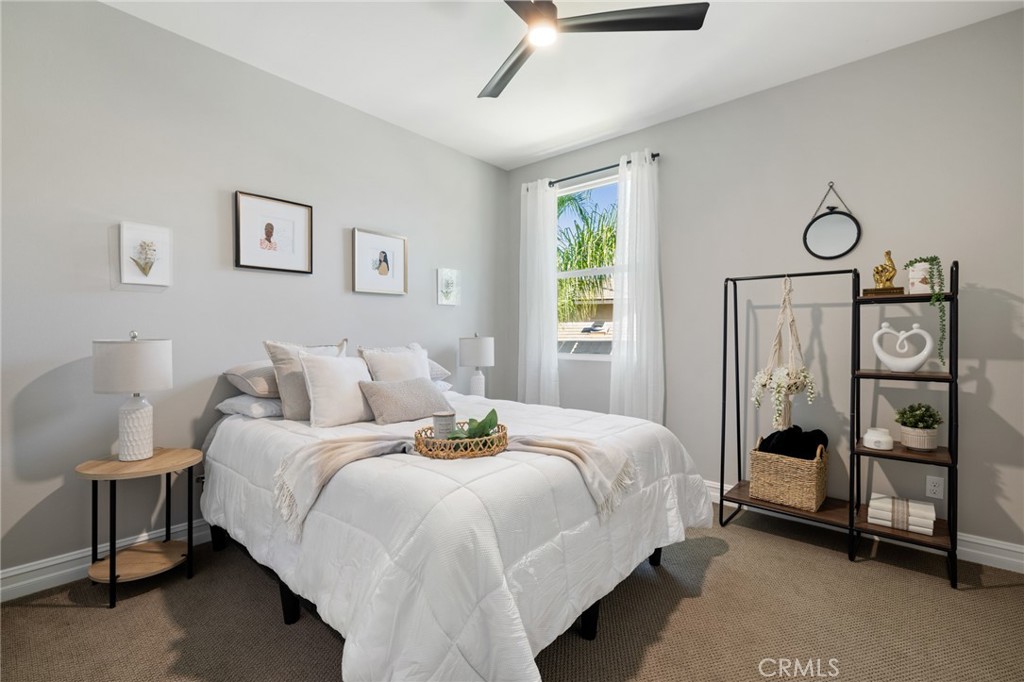 25313 High Noon Court Menifee, CA 92584 - Photo 41 of 73 a bedroom with a bed a mirror and a window