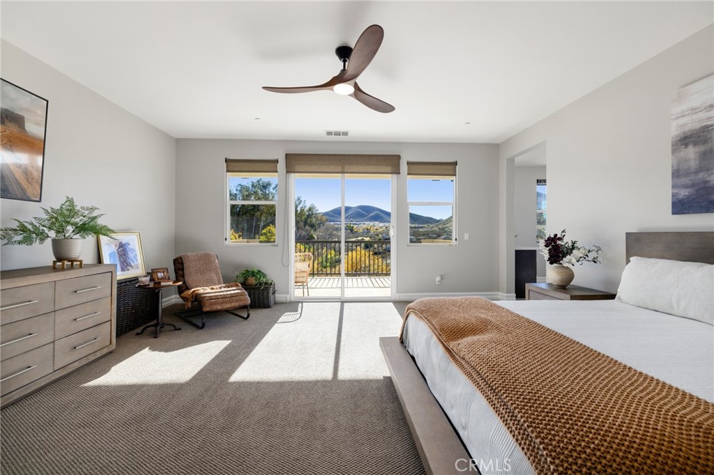 25313 High Noon Court Menifee, CA 92584 - Photo 44 of 73 a spacious bedroom with a large bed and a large window