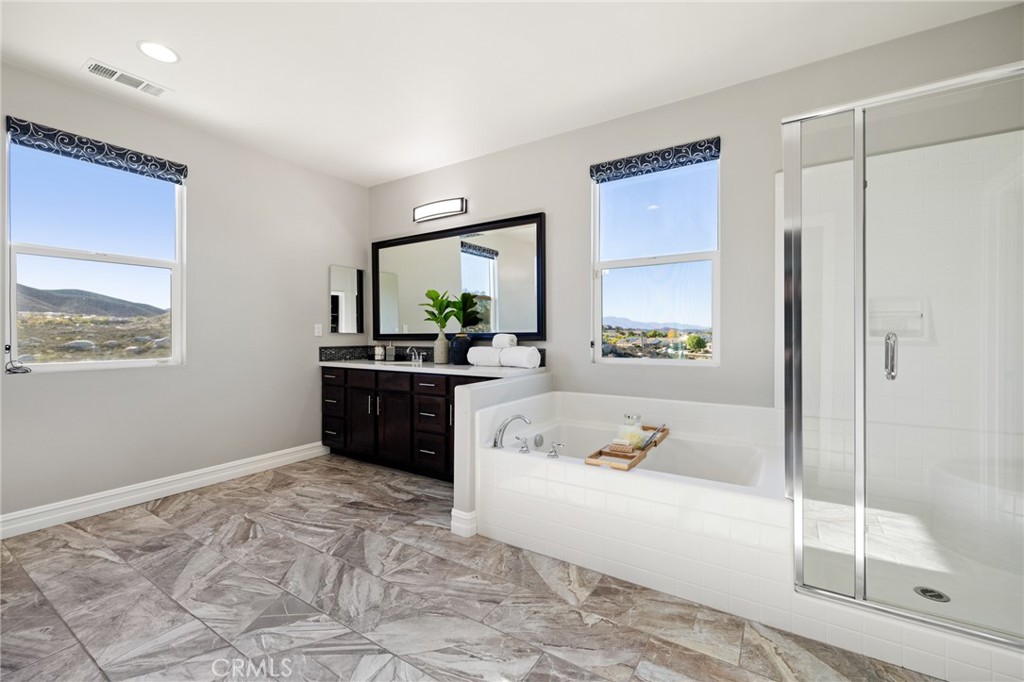 25313 High Noon Court Menifee, CA 92584 - Photo 48 of 73 a bathroom with a tub sink and mirror