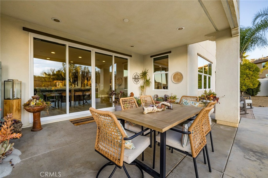 25313 High Noon Court Menifee, CA 92584 - Photo 52 of 73 a view of a dining room and livingroom with furniture wooden floor and a floor to ceiling window