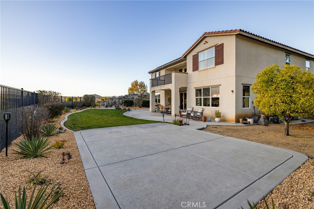 25313 High Noon Court Menifee, CA 92584 - Photo 57 of 73 a view of a white house with a yard and potted plants