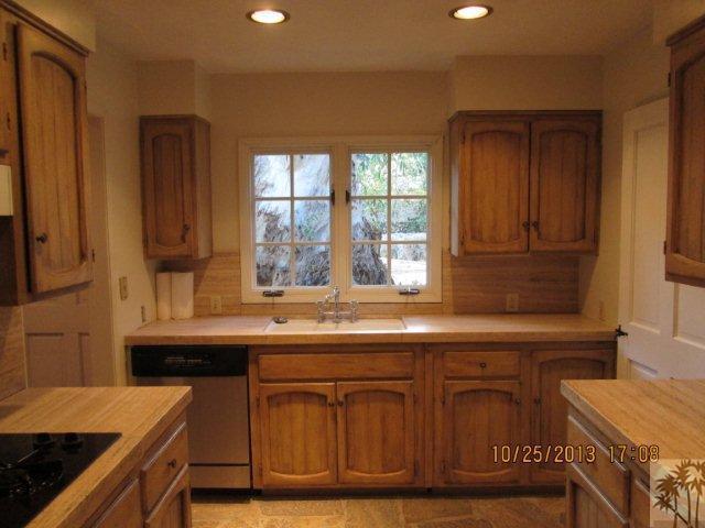 71889 Sahara Road Rancho Mirage, CA 92270 - Photo 3 of 6 a kitchen with kitchen island granite countertop a sink and a stove
